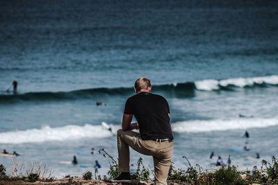 Rear view of man standing on beach