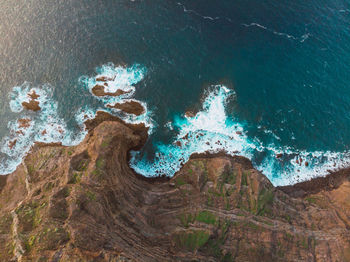 High angle view of rock formations on sea shore