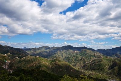 Scenic view of mountains against cloudy sky