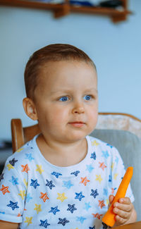 Portrait of cute boy eating food at home