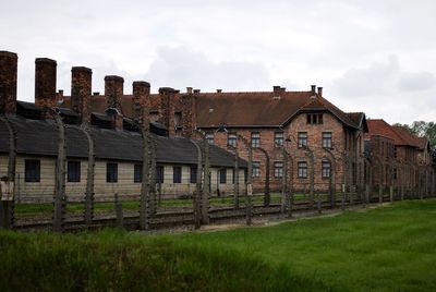 Exterior of old house on field against sky