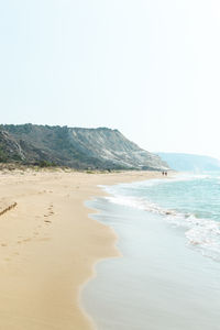 Scenic view of beach against clear sky