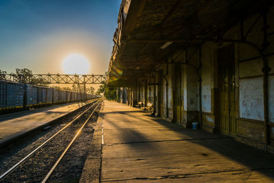 Empty railroad station platform during sunset