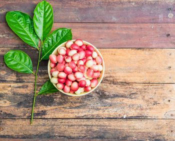 Strawberries in container on wood