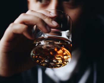 Close-up of man holding beer glass