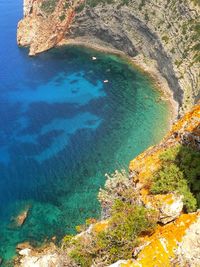 High angle view of rocks by sea