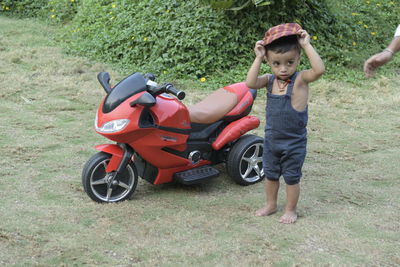 Full length of boy with toy on grass