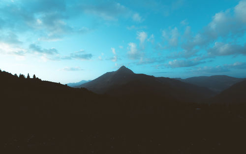 Scenic view of silhouette mountains against sky