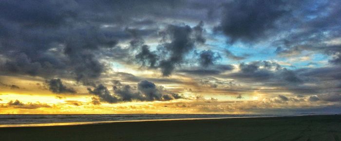 Scenic view of sea against cloudy sky