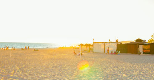 People on beach against sky