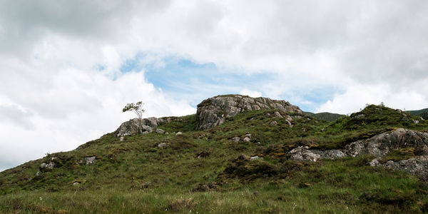 Scenic view of mountains against cloudy sky