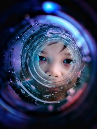 Close-up of boy in glass bottle