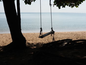 View of swing on beach against sky