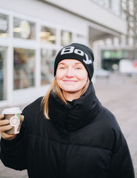 Portrait of smiling young woman standing in winter