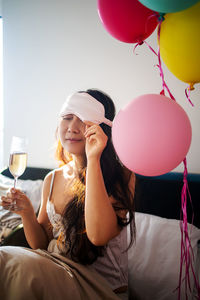 Asian girl celebrate birthday with balloons in bed