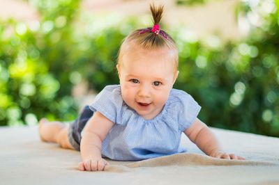 Portrait of cute girl lying outdoors