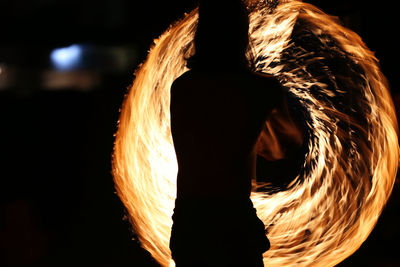 Close-up of man standing against sky at night