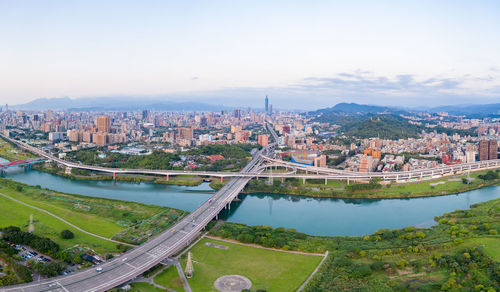 High angle view of river amidst buildings in city against sky