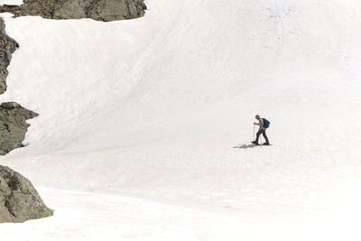 Man walking on snow covered land