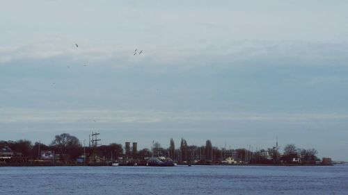 Scenic view of lake against sky during winter