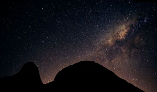 Low angle view of silhouette stars against sky at night