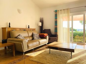 Living room with golden glow from sunlight coming in through sliding glass doors