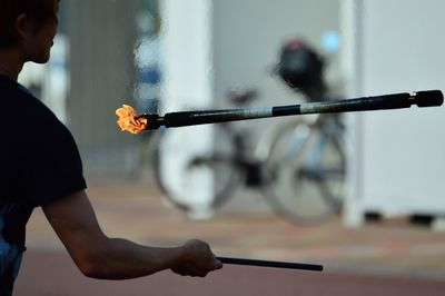 Cropped man performing fire stunt