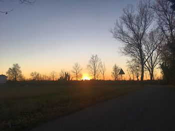 Silhouette bare trees against sky during sunset