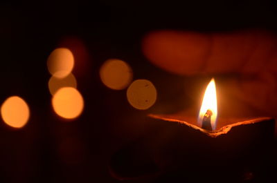 Close-up of lit candles in the dark