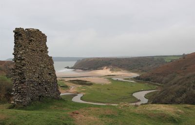 Scenic view of historical ruins against sky and sea