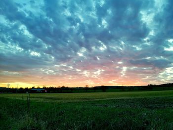 Scenic view of field against sky during sunset