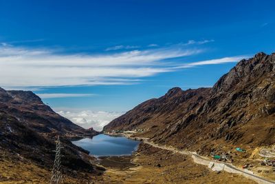 Scenic view of mountains against blue sky