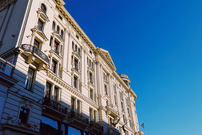 Low angle view of building against clear blue sky