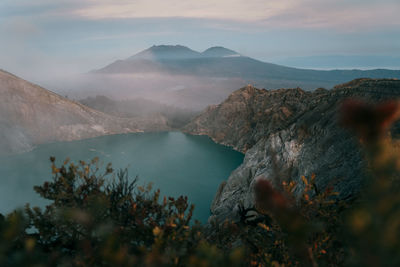 Scenic view of sea and mountains against sky