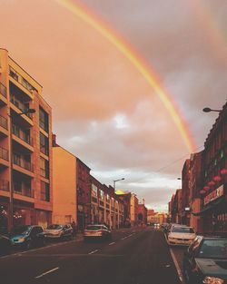 View of rainbow over city street