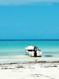 Boat on beach against sky