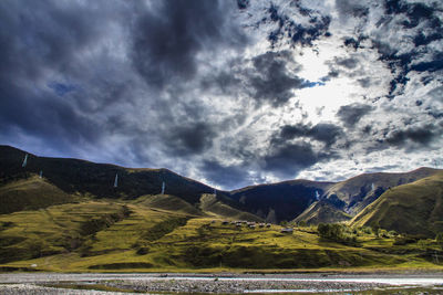 Scenic view of mountains against cloudy sky