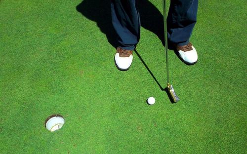 Low section of man playing golf