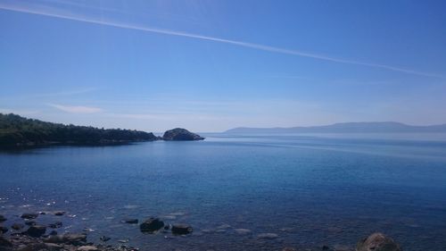 Scenic view of sea against blue sky