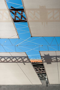 Low angle view of modern building against blue sky