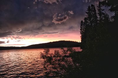 Scenic view of lake against sky at sunset