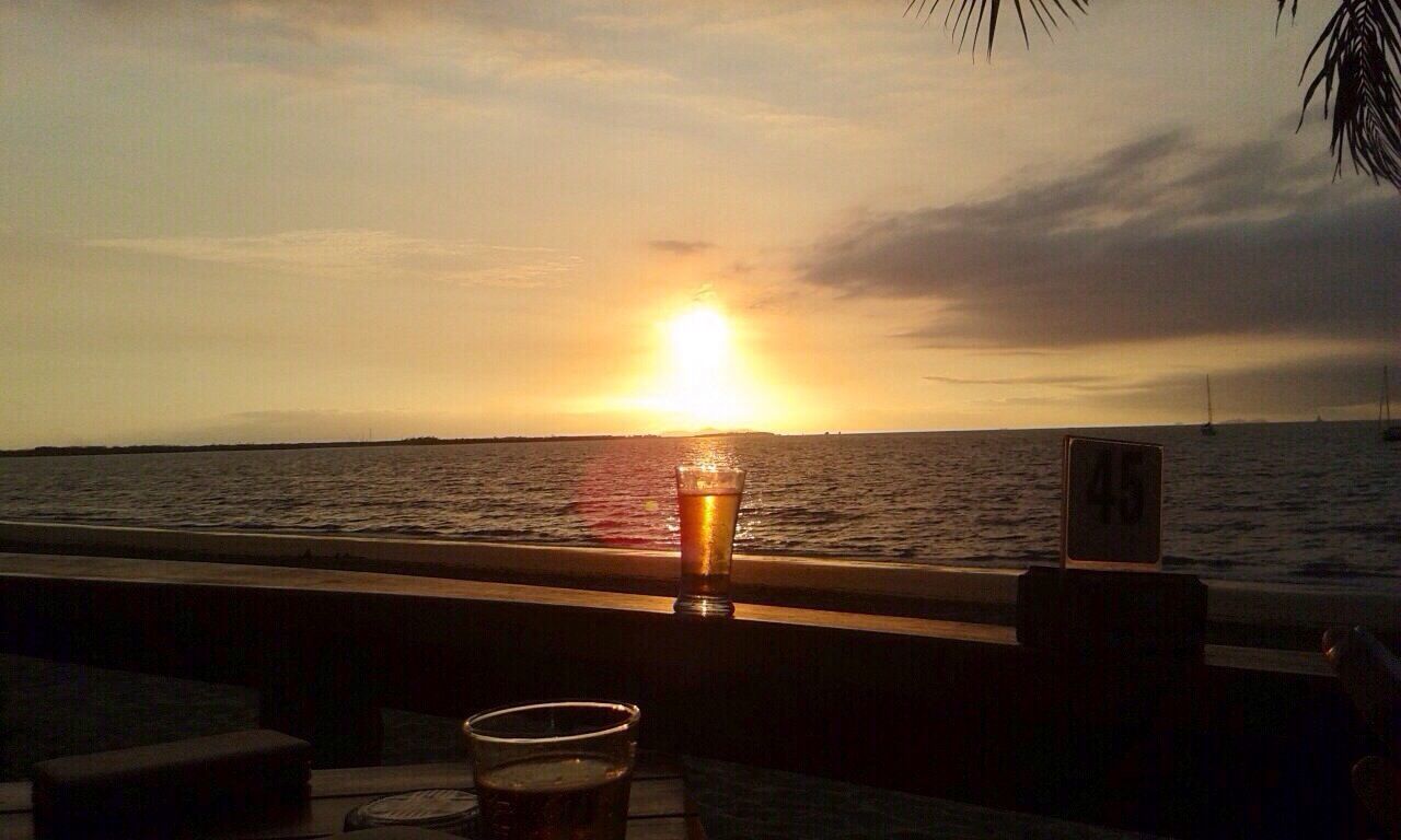 sunset, sea, water, horizon over water, sky, sun, scenics, tranquil scene, beauty in nature, tranquility, cloud - sky, idyllic, nature, orange color, beach, sunlight, cloud, railing, reflection, silhouette