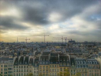 Cityscape against cloudy sky