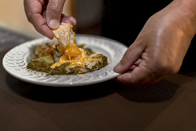 Midsection of person holding ice cream in plate