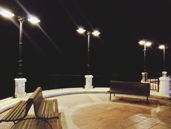 Illuminated lights against sky at night