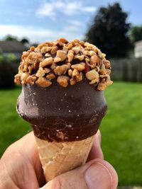 Close-up of hand holding ice cream cone