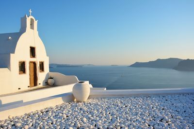 White santorini building and garden against clear sky