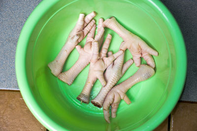 High angle view of chicken meat in green bowl