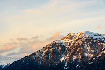 Scenic view of snowcapped mountains against sky during sunset