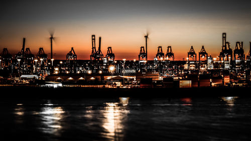 Illuminated commercial dock against sky at night